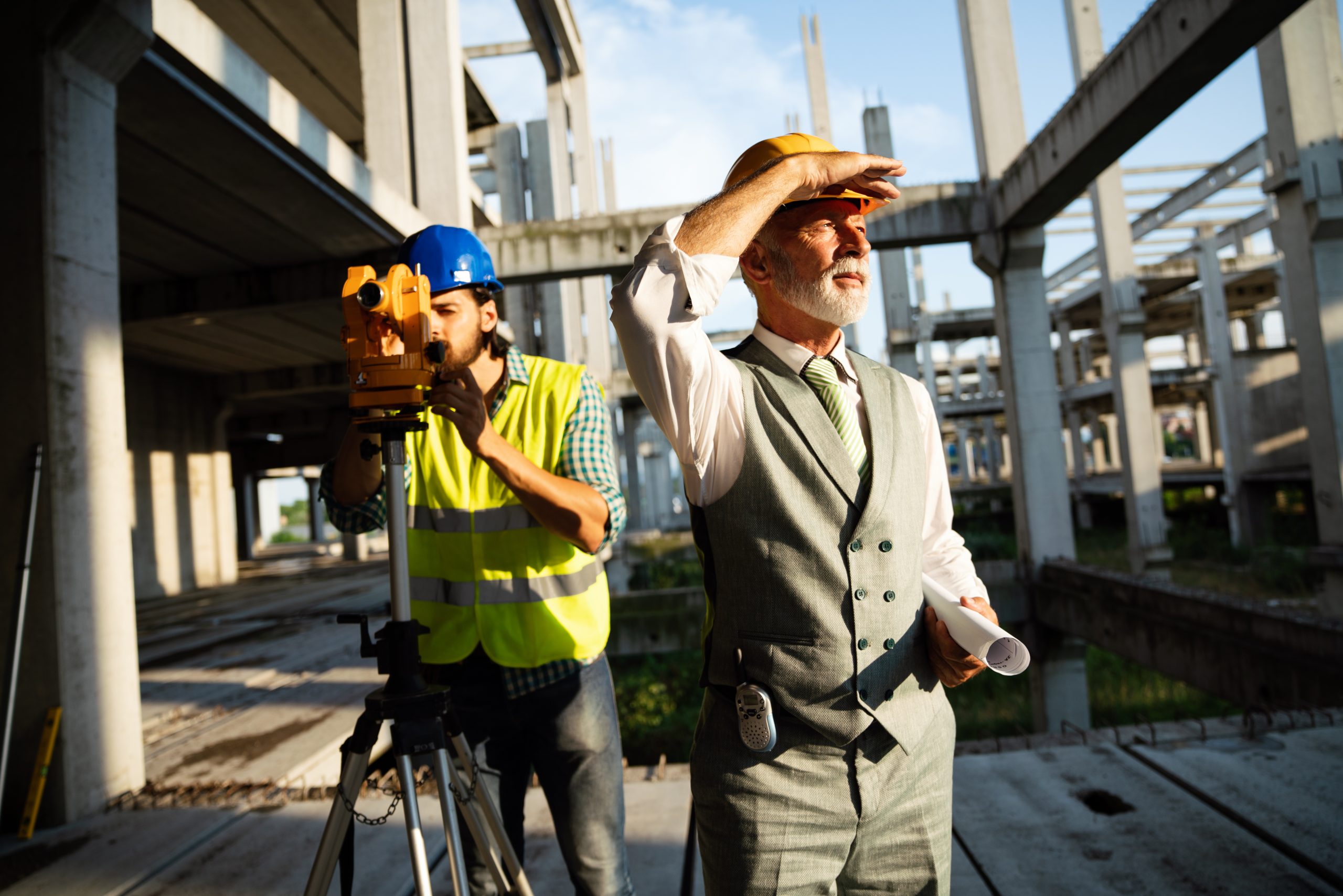 architects, business manager and engineer meeting project at construction site